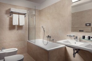 A modern bathroom with a glass-enclosed shower, a freestanding bathtub, a vanity with a sink, and a toilet. - Grandhotel Nabokov Spa & Wellness (Marianske Lazne)