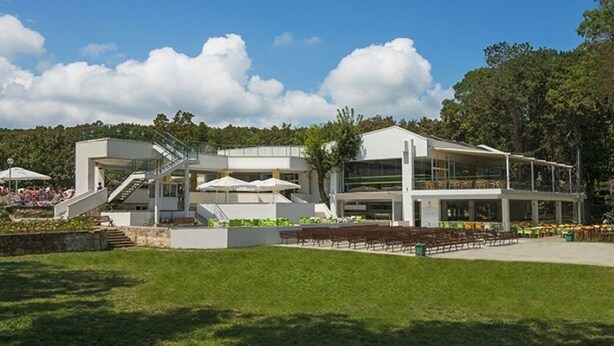 A modern building with a covered outdoor seating area, a staircase, and a flat roof. - Villas Holidays (Kiten)