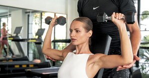 A gym with exercise equipment, including treadmills and dumbbells. - Kiara Ocean Place (Tibubeneng)