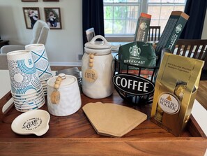 A coffee-themed table setting with various coffee-related items. - Masters 2026 ⛳️- Walk to the course (Augusta)
