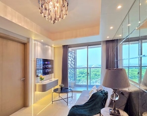 Apartment, 3 Bedrooms, City View | Living area | 43-inch Smart TV with cable channels - By The Pool By SanLiving - 3BR - PIK (Jakarta)