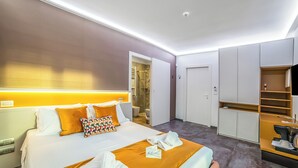 A modern hotel room with a neatly made bed, a walk-in closet, and a bathroom visible through an open door. - Alternative Room 3 Relax & SPA, Scorrano, Italy (Scorrano)