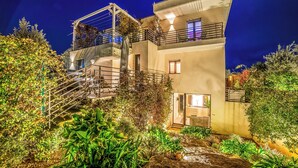 A modern two-story building with a balcony, a staircase, and a garden area. - 4br Luxury Appt - Pool, Garden & Parking, Scorrano, Italy (Scorrano)