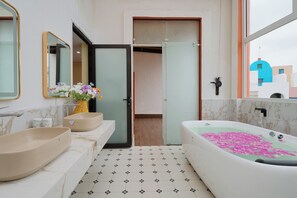 A bathroom with two sinks, a bathtub with pink flowers, and a mirror. - Santori Hòn Thơm Hotel (Phu Quoc)