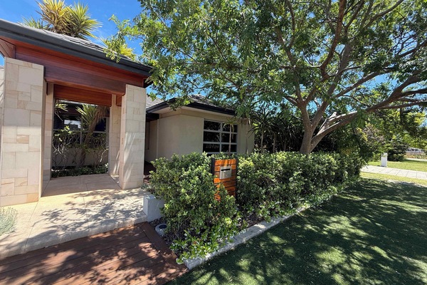 Experience private luxury in this stunning home featuring beautiful stone pillars, a warm timber entryway, and a mature garden sanctuary. The perfect spot for a stylish and relaxing vacation.