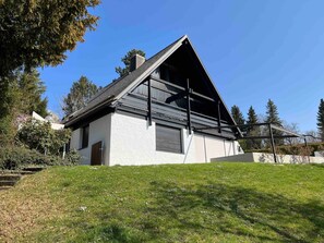 A modern two-story house with a sloped roof, large windows, and a balcony. - mit Pool by Interhome (Nürtingen)