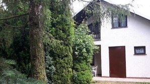 A modern house with a white exterior, a brown door, and a small window. - mit Wasserblick by Interhome (Chocen)