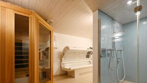 A modern bathroom with a glass-enclosed shower, a wooden cabinet with a mirror, and a bench. - Appartement Alpenblick / C1 by Interhome (Weggis)