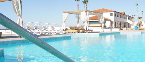 Outdoor pool, open 10:00 AM to 8:00 PM, free cabanas, pool umbrellas