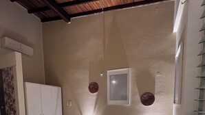 A bedroom with a bed, a wardrobe, and a ceiling fan. - Room 202 with air conditioning (Cúcuta)