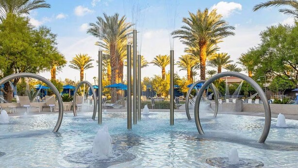 A water fountain with multiple jets, surrounded by palm trees and lounge chairs. - 2-bedroom suite in lovely Club Wyndham Desert Blue in Las Vegas During Formula 1 (Las Vegas)