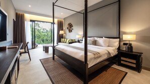 A four-poster bed with a dark wooden frame, a flat-screen TV on the left, and a desk with a chair. - The Clifton Villas Ubud (Ubud)