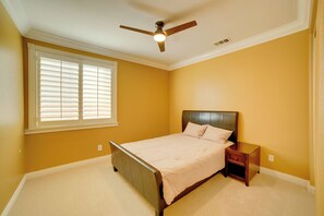 A bedroom with a bed, nightstand, and ceiling fan. - Resort-Style Oasis: Expansive Riverside Mansion (Riverside)