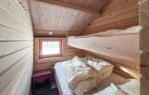 A cabin with a bunk bed, a small window, and a wooden interior. - 3 bedroom awesome home in Sjusjøen (Sjusjøen)