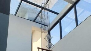 A modern staircase with wooden steps and black railings, leading to a glass ceiling. - Shaionara Villa (Parongpong)