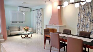 A modern living room with a sofa, coffee table, and fireplace. - Villa Eudora Nafpaktos (Nafpaktos)