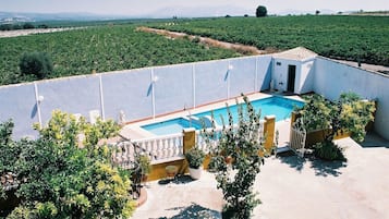 A pool area with a view of a vineyard.
