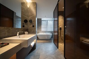 A modern bathroom with a large freestanding bathtub, a separate sink area, and a glass-enclosed shower. - Giorgio Morandi Hotel (Nanjing Yueyahu & NUAA) (Nanjing)