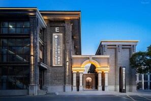 A hotel entrance with a prominent 'E' sign, a brick facade, and an arched doorway. - Giorgio Morandi Hotel (Nanjing Yueyahu & NUAA) (Nanjing)