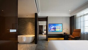 A modern hotel room with a large bed, a bathtub, a television, and a view of the city. - Giorgio Morandi Hotel (Nanjing Yueyahu & NUAA) (Nanjing)