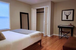 A bedroom with a bed, a desk, a chair, and a closet. - Forsyth Park Place, Unit C - Sleeps 4, Three Minute Walk to Forsyth Park (Savannah)