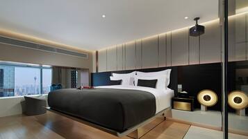 A modern bedroom with a large bed, a city view, and a unique ceiling projector.