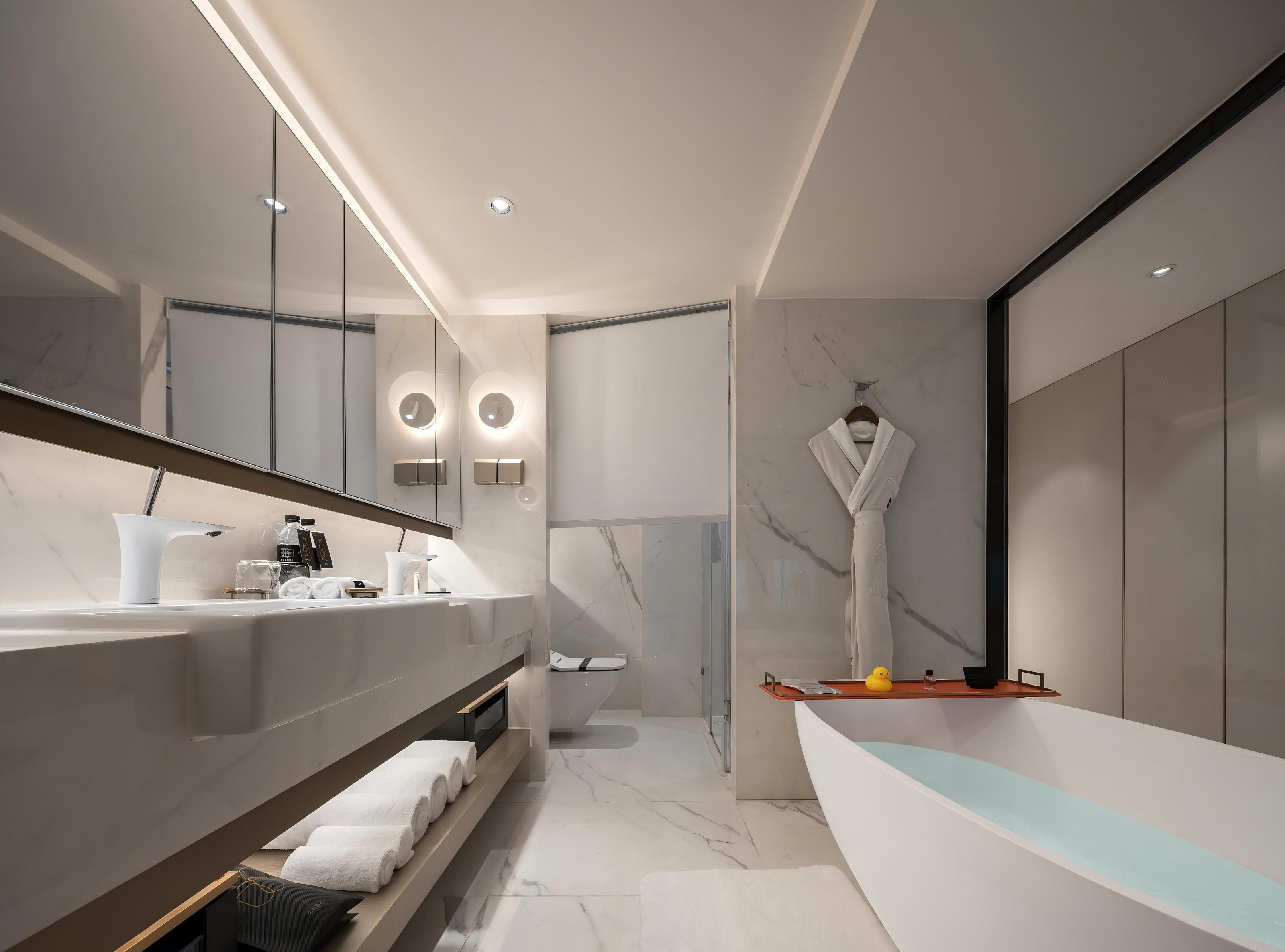 A modern bathroom with a large mirror, two sinks, a bathtub, and a towel rack.