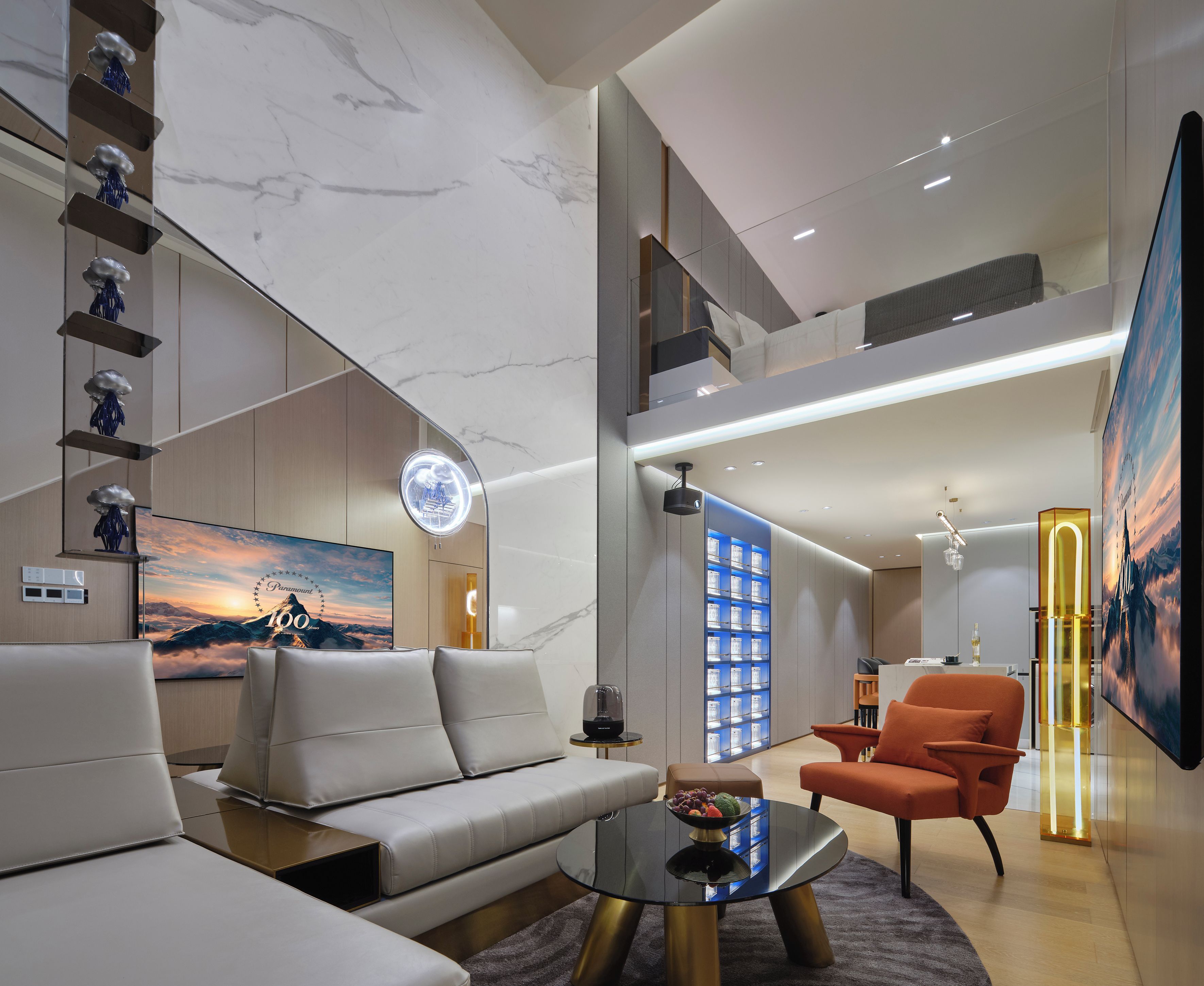 A modern living room with a sofa, coffee table, and orange armchair.