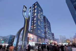 A modern urban scene with tall buildings and a prominent curved structure. - SEYA Serviced Apartment - Chengdu Taikoo Li Flagship - Managed by SEYA GROUP (Chengdu)