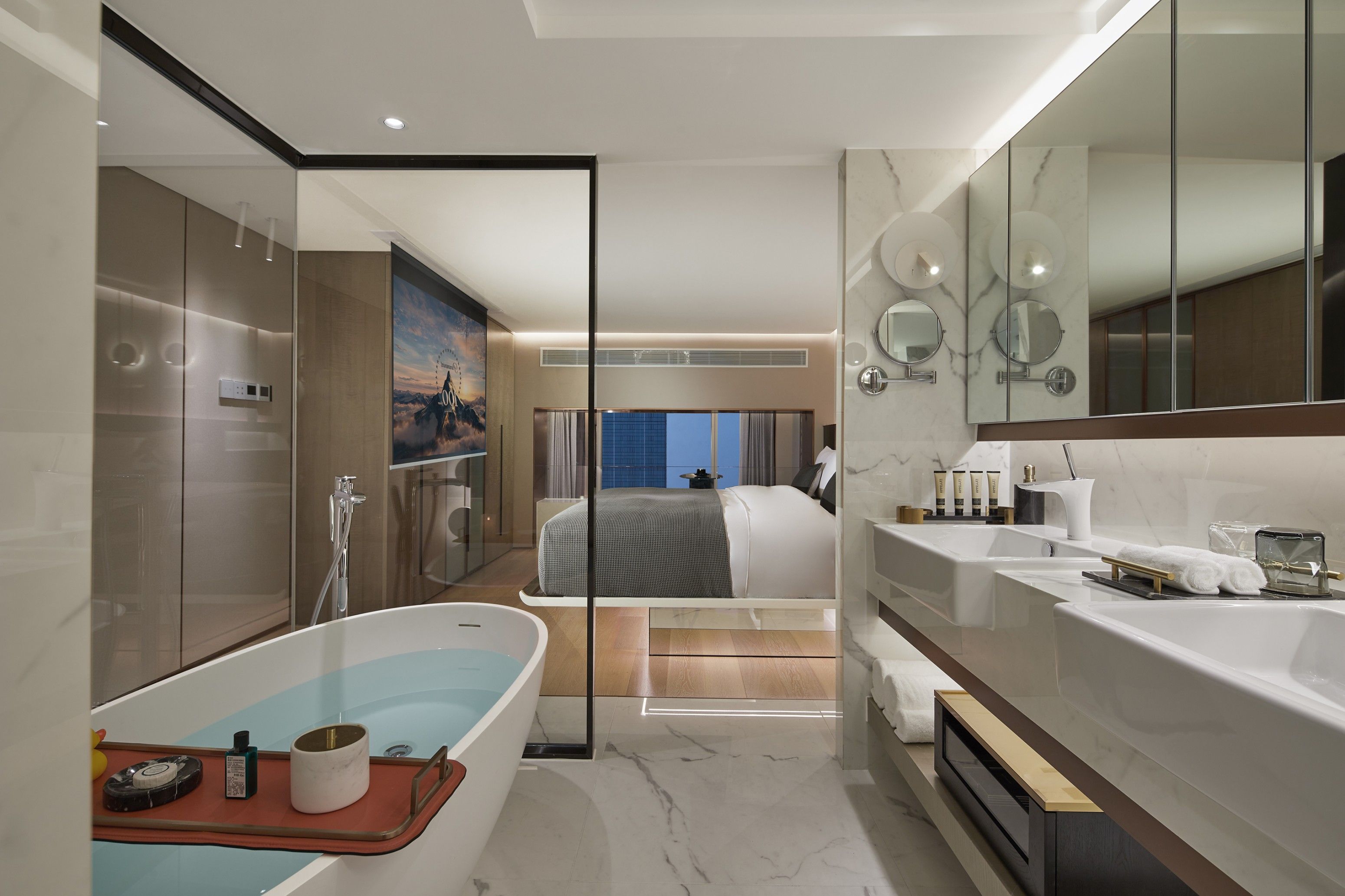 A modern bathroom with a large bathtub, a shower area, and a vanity with a mirror.