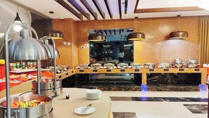 A buffet setup with various food stations, overhead lighting, and a marble-tiled floor. - Ocean Pearl Resort Cox's Bazar (Cox's Bazar)