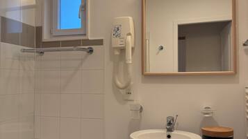 Shower, hair dryer, towels, toilet paper