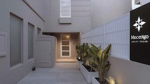 A modern building with a gated entrance, a sign for 'Mocenigo Luxury Rooms,' and a pathway lined with planters. - Chania Mocenigo Luxury Room I - Seaview,15m to sea (Chania)