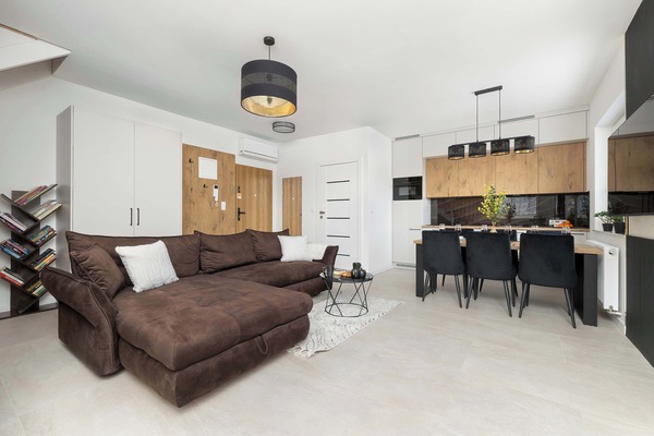 Relax in the stylish living room with a comfortable sofa and modern decor.