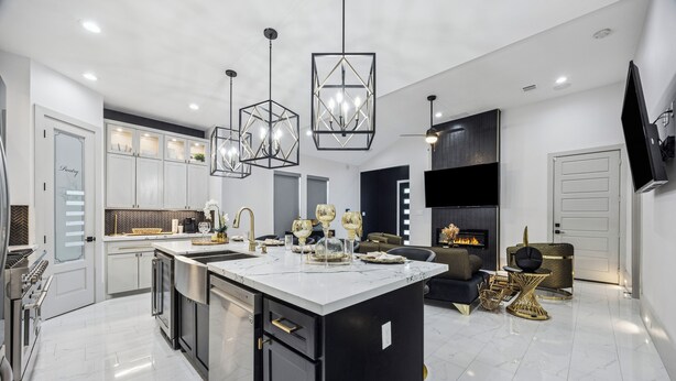 A modern kitchen with a central island, stainless steel appliances, and pendant lighting. - One Story + Generator & Gated Near HTX Medical (Houston)