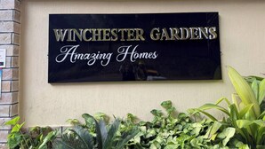 En skylt för ”Winchester Gardens” med sloganen ”Fantastiska hem”.