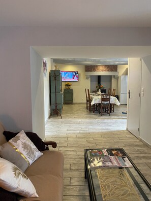 A living room with a sofa, coffee table, and a TV in the background. - *** Clos d'Éden renovated in 2026 between St-Malo and Rennes in a peaceful hamlet (Plesder)