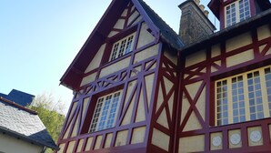 A traditional half-timbered building with exposed wooden beams and a steeply pitched roof.