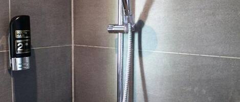 A shower with a handheld showerhead and a handheld shower attachment.