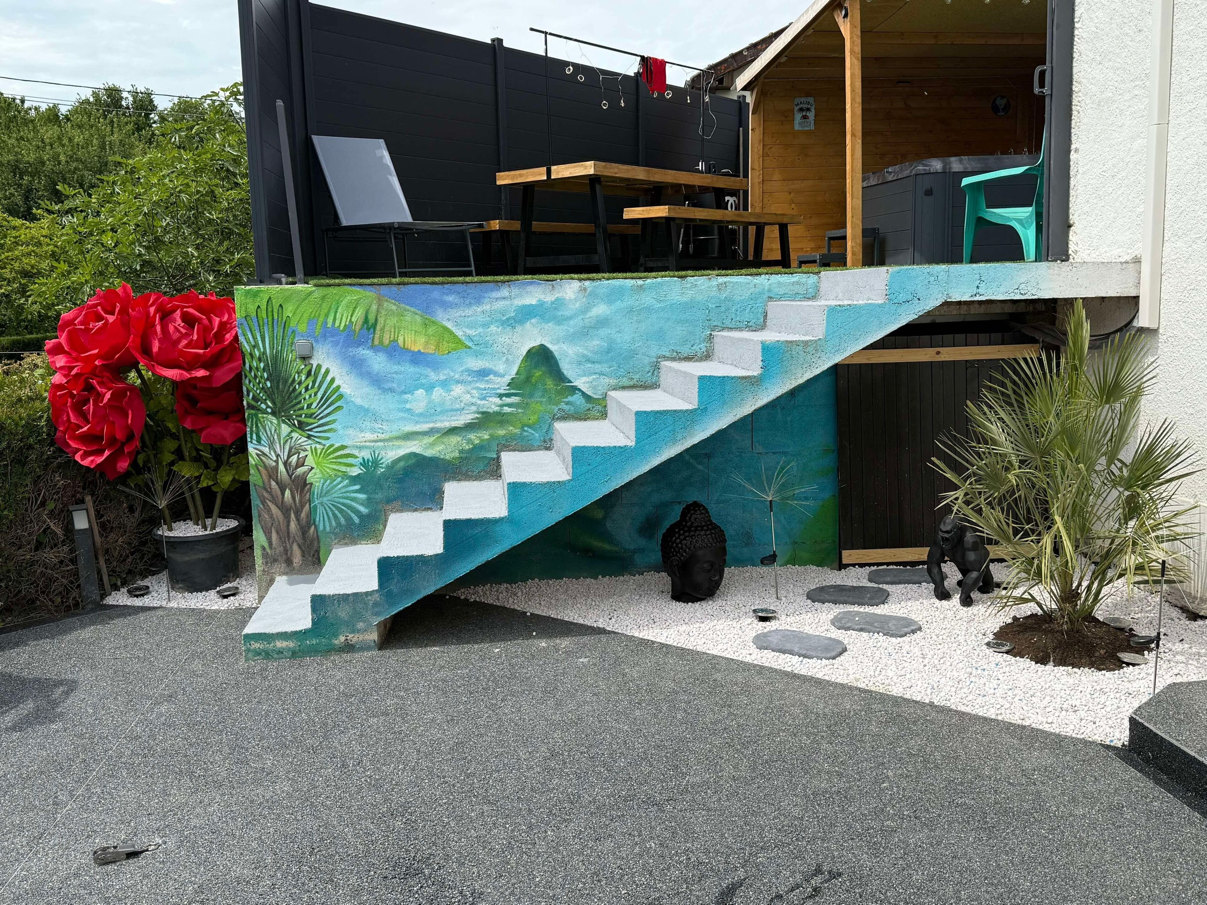 A modern building with a staircase leading to a wooden deck.