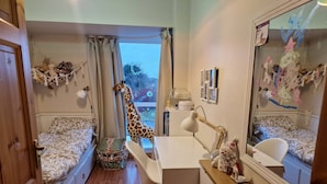 A child's bedroom with a bed, desk, chair, and a giraffe toy. - Cosy Home With Organic Garden (Athenry)