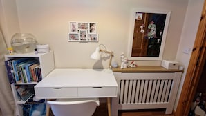 A child's room with a white desk, chair, bookshelf, and radiator. - Cosy Home With Organic Garden (Athenry)