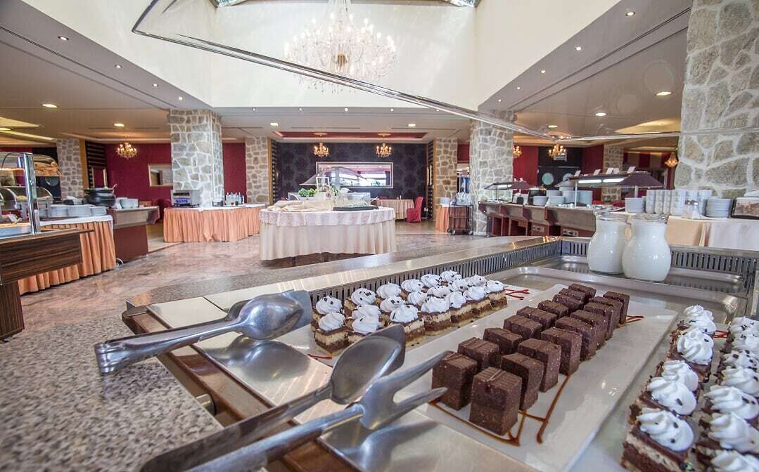 A buffet area with various desserts and a stone pillar.