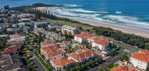 A coastal residential area with houses, a beach, and ocean views. - The Breakers Yamba (Yamba)