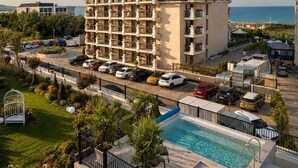 A multi-story hotel with a swimming pool, surrounded by greenery and a clear sky. - Casa dell'Eleganza Event Hall & Hotel (Kranevo)