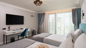 A hotel room with a desk, two beds, a TV, and a balcony view. - Casa dell'Eleganza Event Hall & Hotel (Kranevo)
