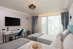 A hotel room with a desk, two beds, a TV, and a balcony view. - Casa dell'Eleganza Event Hall & Hotel (Kranevo)