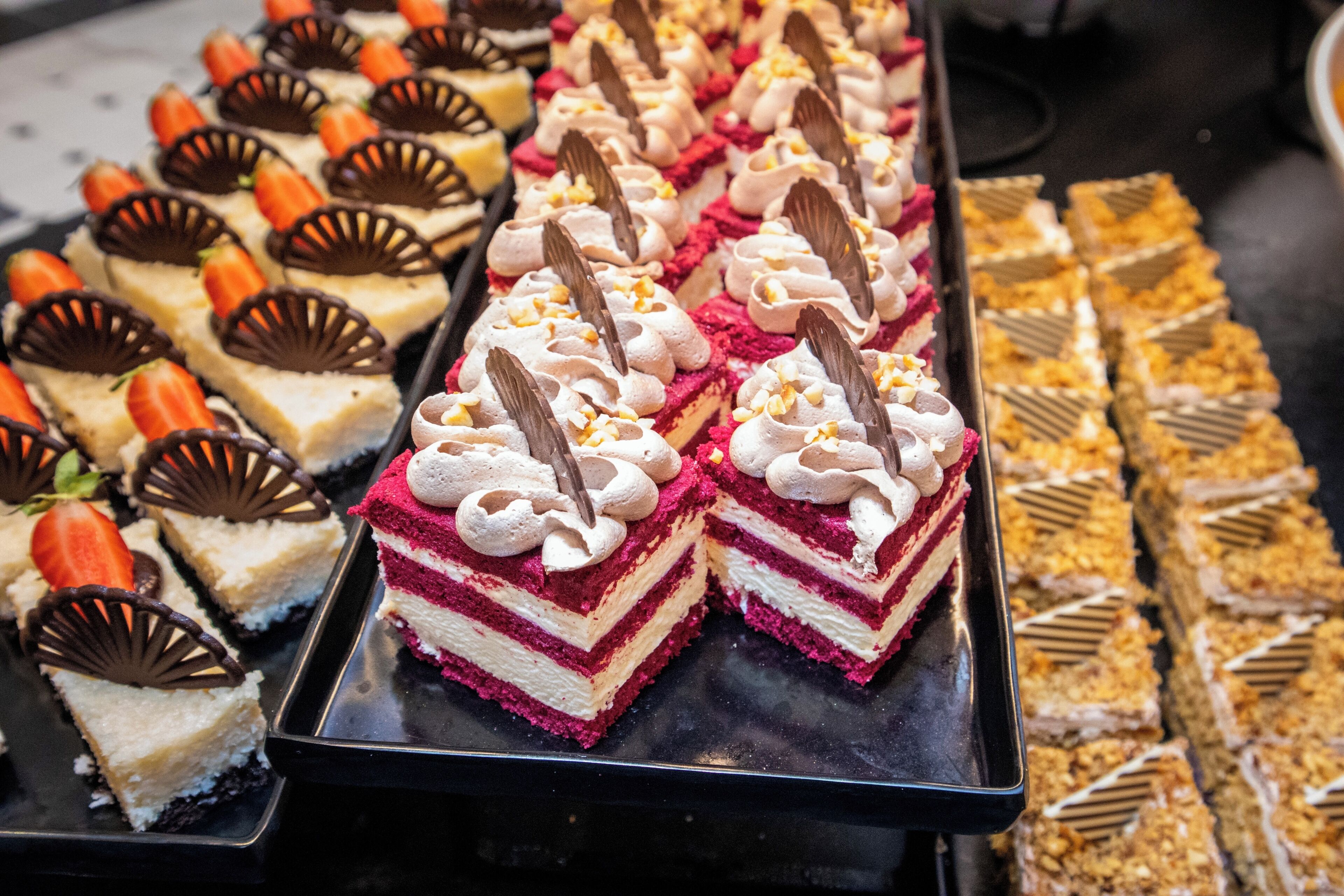 A variety of desserts arranged on trays.