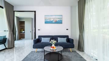 Deluxe Villa | Living area | 32-inch LED TV with cable channels