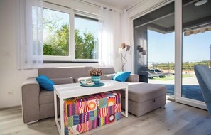A modern living room with a sofa, a coffee table, and a colorful rug. - Villa Venka – Luxury Villa for 8-10 Guests with Private Pool in Central Rab (Palit)
